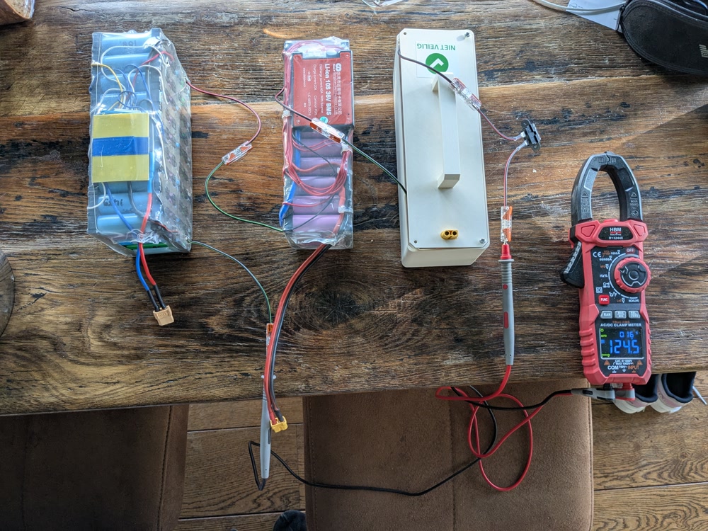 Three 10S batteries hooked up in series. A multimeter is connected, showing 124V.