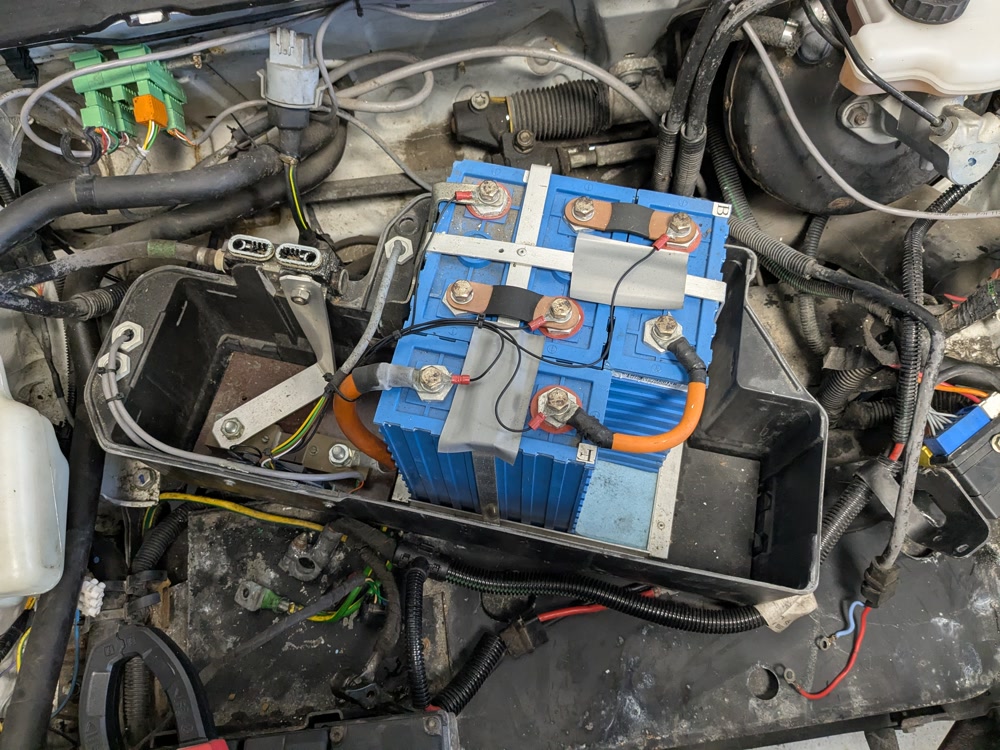 Opened battery casing showing four LiFePO4 batteries